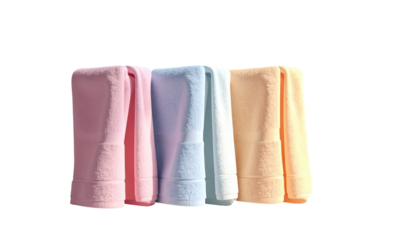 Four neatly folded pastel bath towels in pink, blue, and peach colors, against a contrasting black background