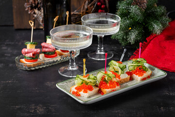 Christmas and New Year's dishes. Snacks and wine drinks for the holiday table. Canapes with red salmon caviar. Overhead