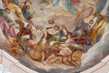 SALZBURG, AUSTIRA - SEPTEMBER 7, 2025: The angels with the music instruments in the cupola of church Dreifaltigkeitskirche (Holy Trinity) by Johann Michael Rottmayr (1679 - 1700).