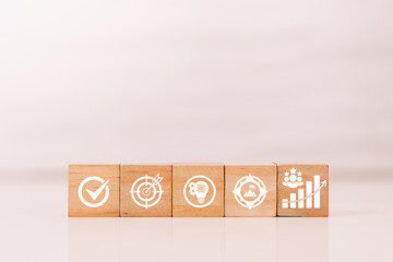 Comprehensive Business Strategy: Row of Five Wooden Blocks with Icons for Goal Achievement Concept