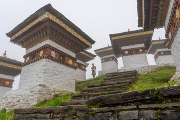 Dochula Chorten, Bhutan - 18 September 2025: View of the ethereal Dochula Pass, with its 108 chortens rising through the misty landscape, their golden roofs gleaming softly against the cloudy sky.