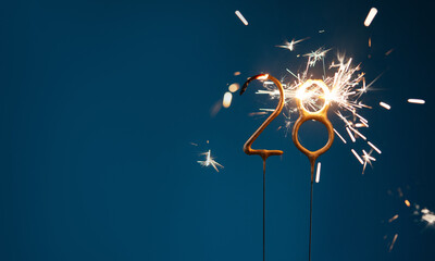 28 years celebration festive background with copy space made with Bengal fires in the form of...