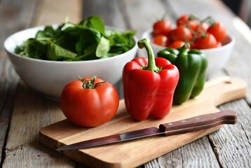 Vibrant fresh vegetables on a rustic cutting board with spinach&hellip;