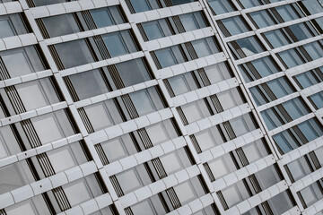 Modern corporate architecture showing abstract glass facade pattern and precise geometry of an office building used as design background