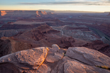 Dead Horse Point State Park in San Juan County, Utah, dramatic view of the Colorado River and Canyonlands National Park in Utah, Page, USA. Deserts, rocks, ledges, and mountains. Beautiful sunset