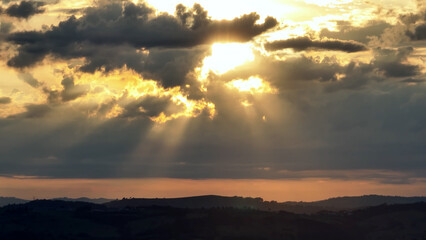Obraz premium Rays Of Sun In Sunset Landscape Mountains Brazil. Captivating Aerial View Of Plantations Forming Geometric Patterns. Sunset Nature Sky Sky Rural Panorama. Sunset Landscape Mountains.