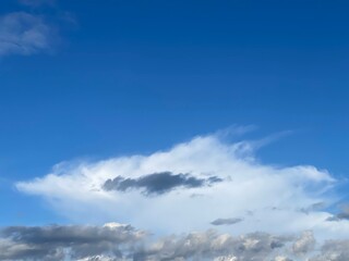 Blue sky with white and gray clouds. The image creates a peaceful and scenic nature view