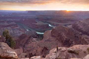 Dead Horse Point State Park in San Juan County, Utah, dramatic view of the Colorado River and Canyonlands National Park in Utah, Page, USA. Deserts, rocks, ledges, and mountains. Beautiful sunset