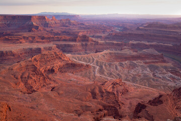 Dead Horse Point State Park in San Juan County, Utah, dramatic view of the Colorado River and Canyonlands National Park in Utah, Page, USA. Deserts, rocks, ledges, and mountains. Beautiful sunset