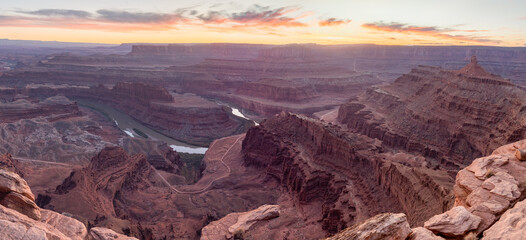 Dead Horse Point State Park in San Juan County, Utah, dramatic view of the Colorado River and Canyonlands National Park in Utah, Page, USA. Deserts, rocks, ledges, and mountains. Beautiful sunset
