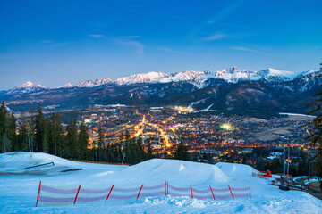 Tatry mountains at blue hour seen from Gubalowka hill in Zakopane. Poland
