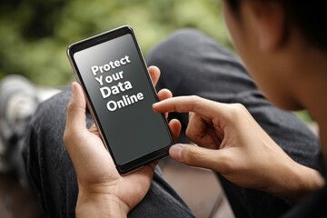 Over the shoulder shot of a teenage boy holding a smartphone with protect your data online text on screen, concept of digital privacy, cyber security and information safety for internet users