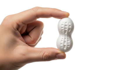 Person Holding Small White Peanut Shape Against Black
