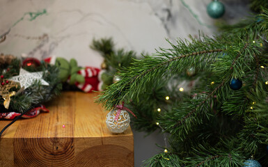 Cozy Christmas home interior with fir branches, ornaments and wooden table, festive holiday decor creating warm seasonal atmosphere
