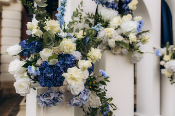 Wedding arch floral decoration with white and blue flowers
