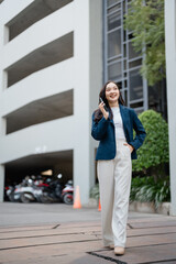 Fototapeta premium Happy businesswoman walking and talking on phone