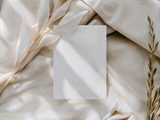 Minimal invitation card mockup with soft fabric leaves and natural light shadows