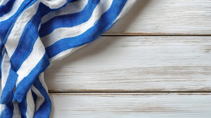 Blue linen cloth lies folded on rustic wooden surface