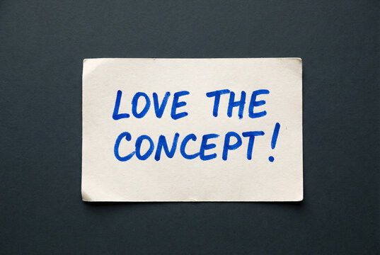 Naklejki Love the concept handwritten quote card on dark wooden desk, inspirational feedback message for creative ideas.