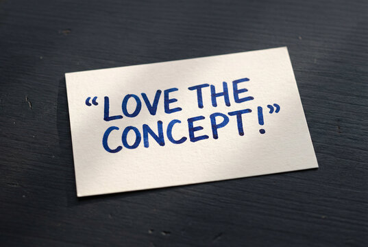 Naklejki Love the concept handwritten quote card on dark wooden desk, inspirational feedback message for creative ideas.