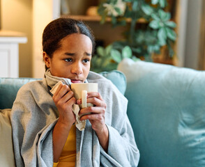 Portrait of a sick young black teenage girl at home, virus or flu illness, recovery at home