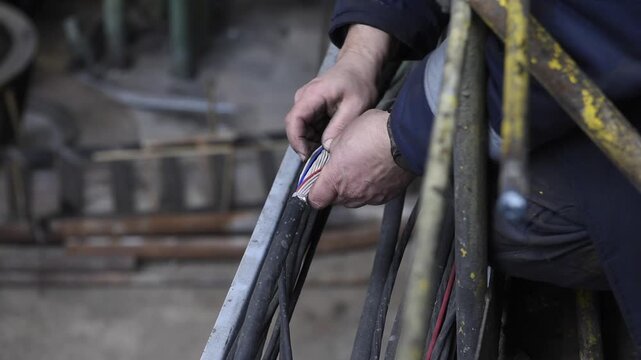 electrician checks the wiring harness for damage