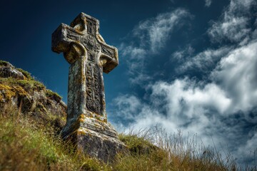 Historic cross monument in nature, textured stone and clouds above