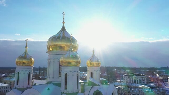 Aerial close-up view of golden domes of Catherine Cathedral in Pushkin covered with snow on a sunny winter day