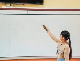 Teacher Asian teaching students in classroom. Professional development writing whiteboard classroom activity. Back to school. Female teaching lesson education, brainstorming, studying. Knowledge 