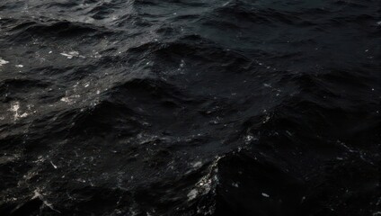 Fototapeta premium Mysterious dark ocean water with subtle light reflections.