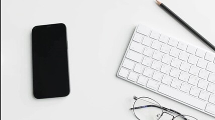 Overhead view of smartphone and tripod on an office desk in 4K, showing professional workspace setup, content creation tools, detailed arrangement, and visually engaging modern office and tech visuals