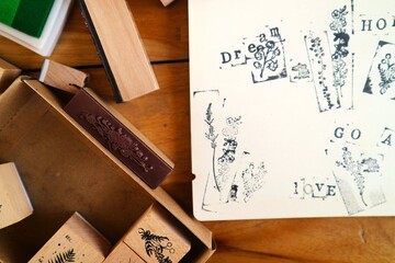 Wooden rubber stamps and supplies for journaling and scrapbooking. These stamps feature floral, botanical, and vintage-style lettering motifs popular for decorating diaries, cards, and other craft pro