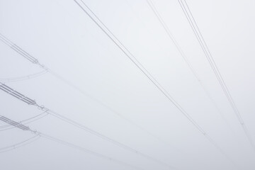 Electric cable wire in fog weather. Minimalism composition, distribution of power, simple industrial background