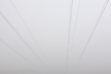 Electric cable wire in fog weather. Minimalism composition, distribution of power, simple industrial background