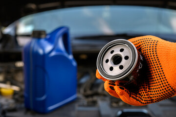 Auto mechanic holding a new oil filter