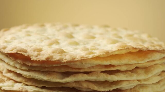 Stack of Baked Cake Layers Rotating: Close-up of crispy golden puff pastry crusts for traditional Napoleon cake or mille-feuille dessert