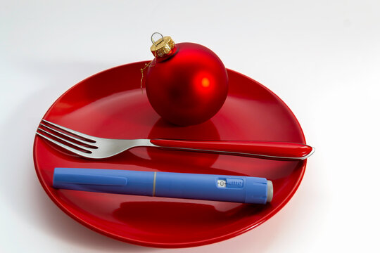 Holiday Diet Concept with Injection Pen like ozempic on Red Plate. copy space, isolated
