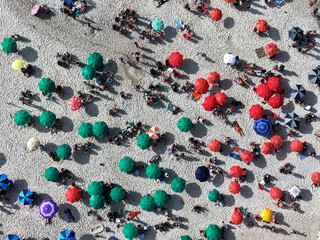 Rio de Janeiro, Brazil, top view of Copacabana Beach showing colourful umbrellas and people relaxing on a summer day. Tropical travel and vacation concept.