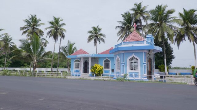 Chinchinim, Goa, India - May 20th 2024 - Shot of vehicles passing by Chapel of Glorious Saint Sebastian Nx.