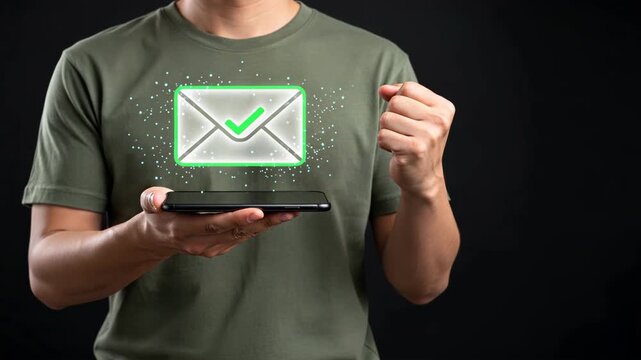 A man celebrating while a holding smartphone with glowing green check envelope showing email verification and secure communication success