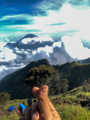 Finger Heart Sign with Mountain Landscape Background