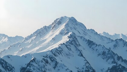 Close-up of a snow-dusted mountain ridge under a pale sky.