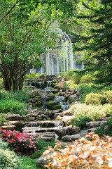 Majestic Garden Landscape with Waterfall and White Birdcage Gazebo