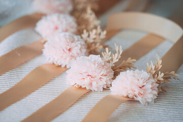 Row of Pink Flower Wrist Corsages with Gold Ribbons for Bridesmaids
