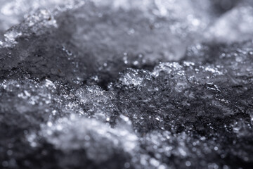 Snow close-up on a dark background. melting ice. 
