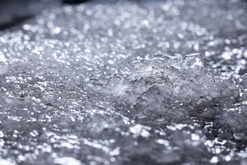 Snow close-up on a dark background. melting ice. 