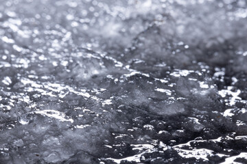 Snow and ice close-up on a dark background. Abstract winter background.