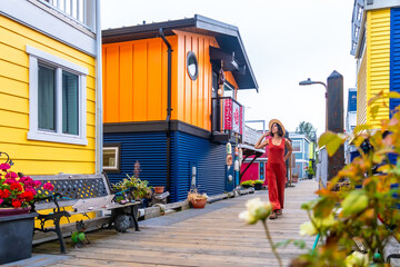 Tourist walking on fisherman's wharf in victoria, british columbia