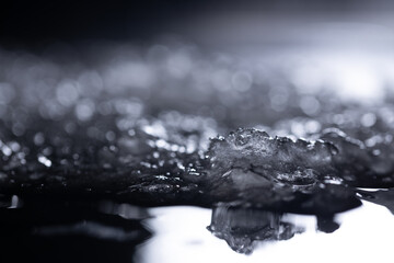 Snow close-up on a dark background. melting ice. 