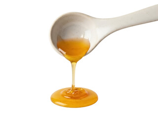 Isolated shot of flowing liquid amber honey pouring from a spoon, viscous and sweet